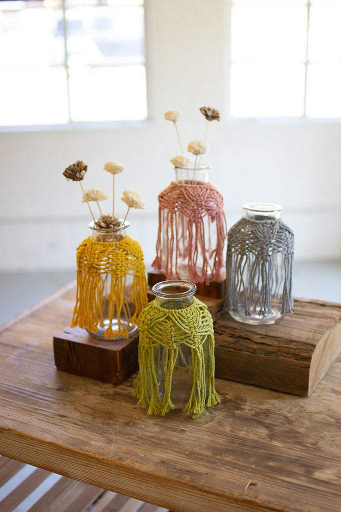 set of four glass bud vases with cotton macrame collars